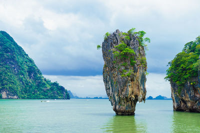 Scenic view of rock formation in sea against sky