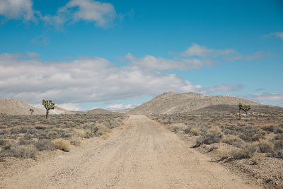 Scenic view of desert against blue sky