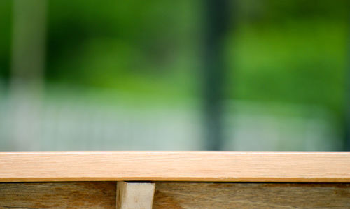 Close-up of wooden railing on table