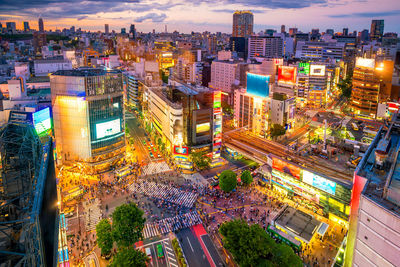 High angle view of illuminated city street and buildings at night