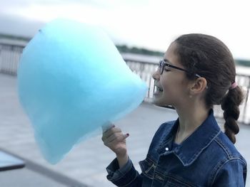 Close-up of girl eating candy floss