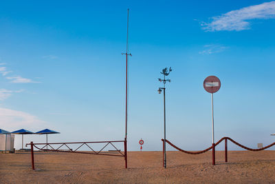 Street lights against blue sky