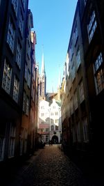 Street amidst buildings against sky