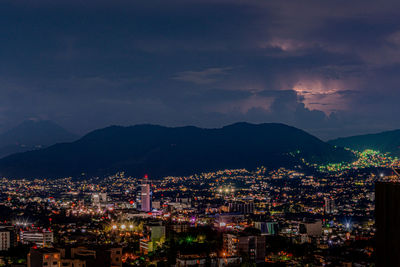 High angle view of townscape against sky during stormy night