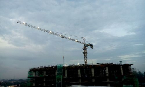 Low angle view of crane against sky