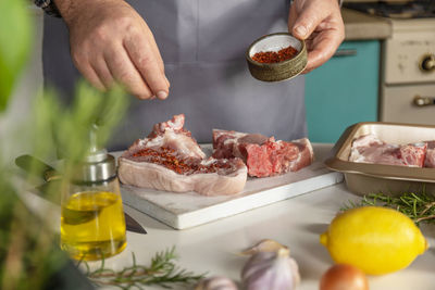 Midsection of man preparing food on table