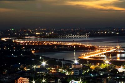 High angle view of illuminated buildings against sky at night