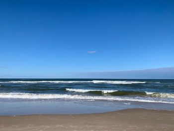 Scenic view of sea against clear blue sky