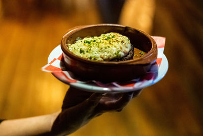 Close-up of person holding ice cream in bowl