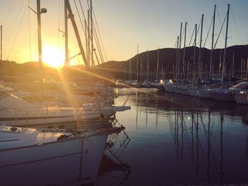 Boats in marina at sunset