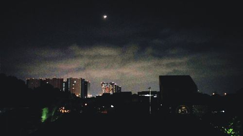 Silhouette of buildings against sky at dusk