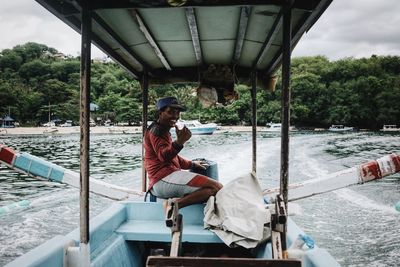 People sitting on boat in sea