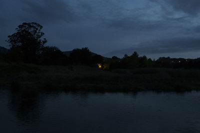 Scenic view of lake against sky at night