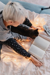 High angle view of woman reading book