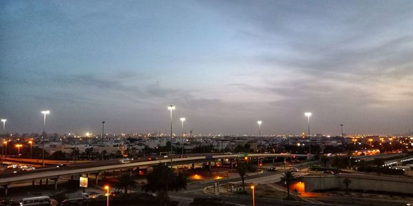 High angle view of illuminated city against sky at night