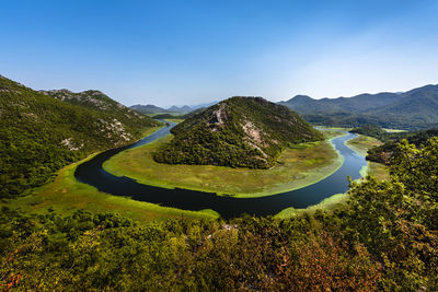 Scenic view of mountains against clear blue sky