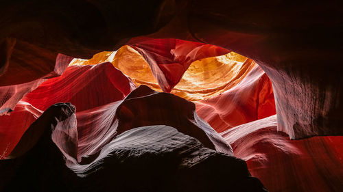 Low angle view of red rocks on rock