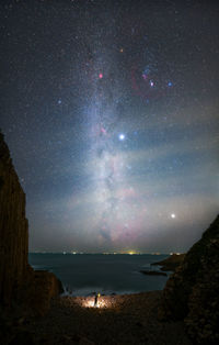 Scenic view of sea against sky at night