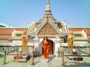 Full length of woman standing against temple