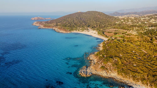 Scenic view of sea and mountains against sky