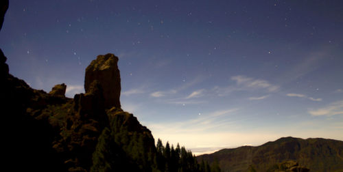 Rock formation against sky at sunset