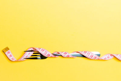 Close-up of colored pencils against yellow background