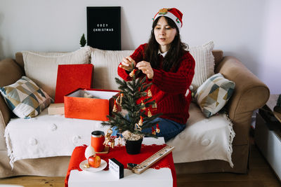 Portrait of smiling woman using laptop while sitting on table