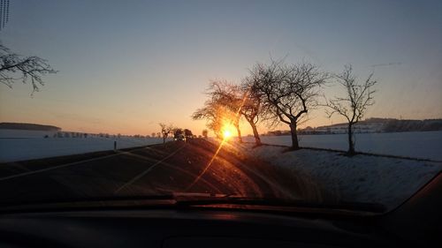 Car on road against sky during sunset