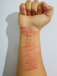 Close-up of human hand against white background