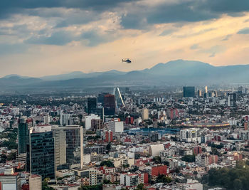 Aerial view of buildings in mexico city against sky