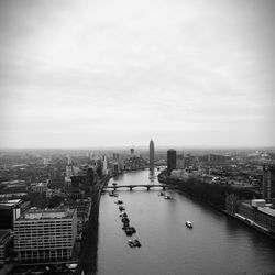 Aerial view of city against cloudy sky