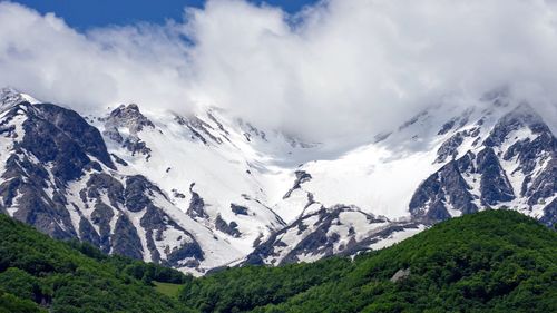 Scenic view of snowcapped mountains against sky