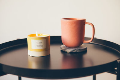 Close-up of coffee cup on table against white background