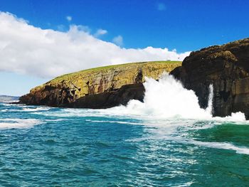 Scenic view of sea and rock formation against sky