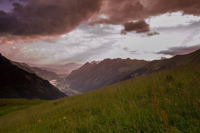 Scenic view of mountains against cloudy sky