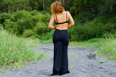 Rear view of woman standing outdoors