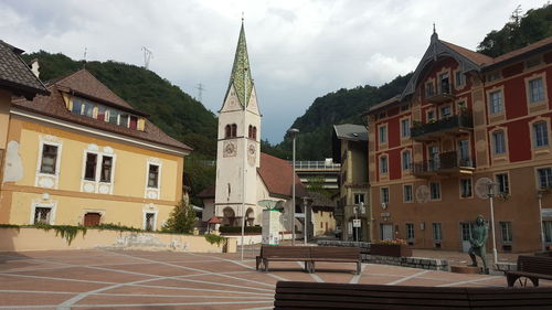 Residential buildings in town against sky