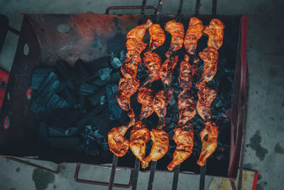 High angle view of meat on barbecue grill