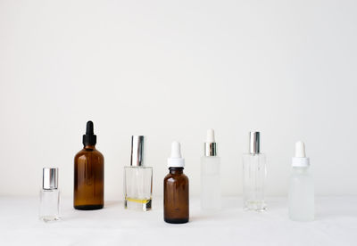 Close-up of bottles on table against white background