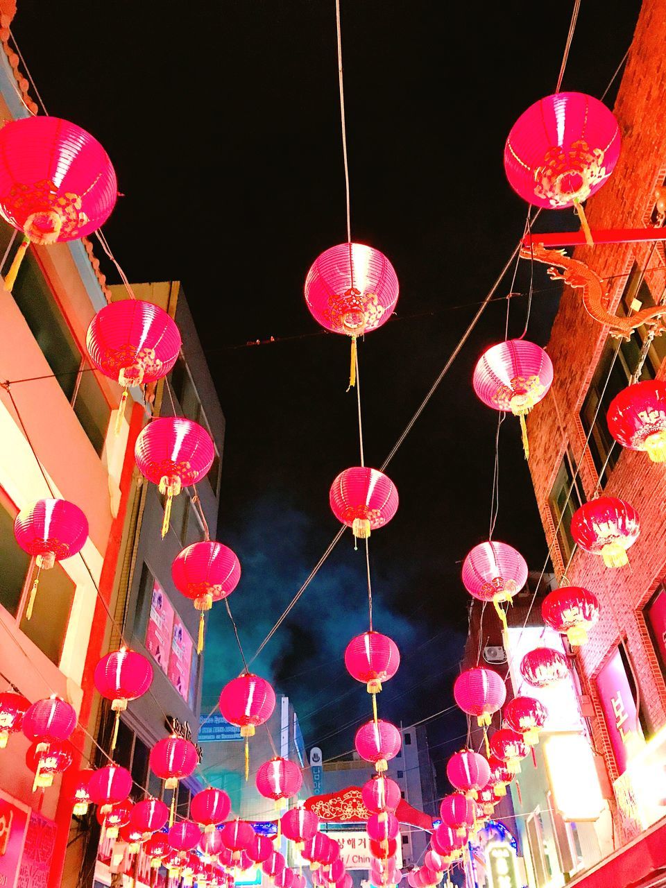 hanging, celebration, decoration, low angle view, lighting equipment, night, pink color, chinese lantern, illuminated, cultures, variation, lantern, no people, chinese new year, multi colored, outdoors