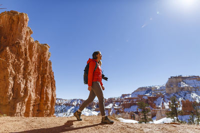 Hiker walking on mountain against clear sky at bryce canyon national park during winter