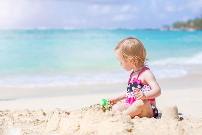 Boy sitting on beach