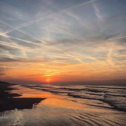 Scenic view of beach against sky during sunset