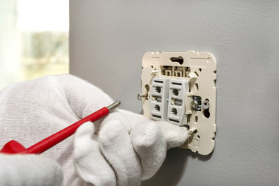 Close-up of telephone booth against white wall at home