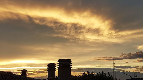 Low angle view of silhouette building against sky during sunset