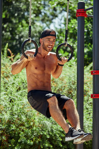 Side view of man exercising in playground