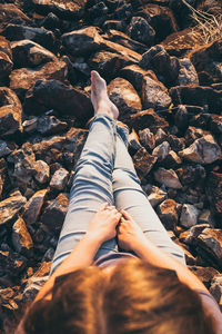 Low section of woman lying on rock