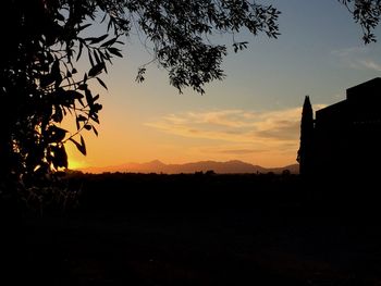 Scenic view of silhouette landscape against sky at sunset