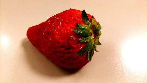 Close-up of red strawberry over white background