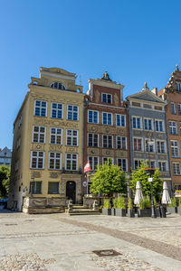 Low angle view of buildings against blue sky